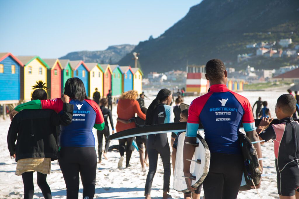 Waves For Change employees and participants walking on the beach